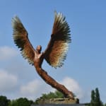 Figurative bronze sculpture of mythical Greek winged figure Icarus by Nicola Godden, displayed on plinth.