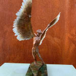 Figurative bronze sculpture of mythical Greek winged figure Icarus by Nicola Godden, displayed on plinth.