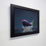 Still life of an eggplant in a glass bowl with a tiled background