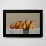 Orange and yellow fruits, vegetables, and cups on grey cloth