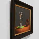 Silver golf trophy on green napkin in swing towards chocolate covered donut