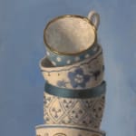painted stack of tea cups on blue background