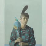 Woman sitting with blue and yellow pheasant on shoulder
