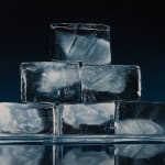 large ice cubes stacked in a pyramid with blue background