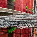 low viewpoint of a puddle on a narrow Tribeca Street
