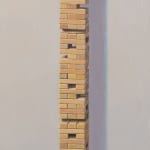 Painting of a globe atop a tall tower of jenga blocks