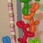 Painting of balloon dogs stacking ice cream scoops