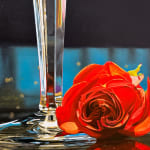 Two Crystal Champagne Glasses fill with bubbly and accompanied by a rose.