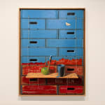 Painting of stacked crates and an apple with a bucket of paint