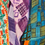 4 Women in colorful fabric clothing over an orange background
