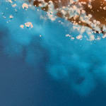 Woman in a red bikini diving through blue water