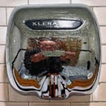 Painting of the artist reflected in a hand dryer