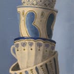 painted stack of tea cups on blue background