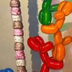 Painting of balloon dogs stacking ice cream scoops