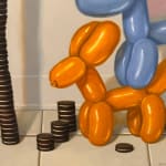 Painting of balloon dogs on top of each other stacking a tower of oreos