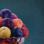 Bowl of plums with water droplets