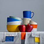 Still life of stacked bowls and two apples