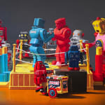 Rock-em Sock-em robots fight with other robot toys watching
