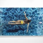Mixed media and resin work of aerial view of girl swimming on canvas