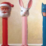 Detail of Three PEZ dispensers in a row facing out of the painting. From left to right it is Santa Claus, a white bunny with big ears, and batman.