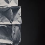 Detail of Column of 4 white origami paper boxes stacked and leaning forward