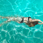 Woman in black bikini swimming in a pool
