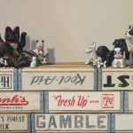 Cat and dog figurines atop stacked soda crates