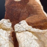 Painting of a white and brown lemur sitting on a a brown platform