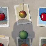 Painting of apple snapshots with a "real" apple hanging from a string and a shadow obstructing the view