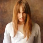 Portrait painting of a woman with blonde hair and white shirt