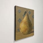 Pear sitting on table with blue design in background
