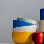 Still life of stacked bowls and two apples