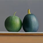 Watermelon and zucchini sitting on table barely touching