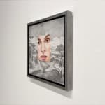 Painting of a face on a landscape background
