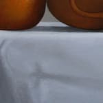 Orange and yellow fruits, vegetables, and cups on grey cloth