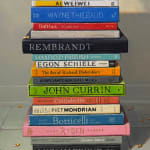 Still life painting of a stack of books with a toy bird atop