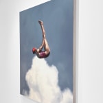 Woman in pink bathing suit soaring above the clouds