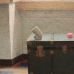 Image of a green trunk in a room filled with sunlight and a red, blue and white floor
