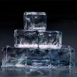 Ice cubes stacked in a pyramid with black background