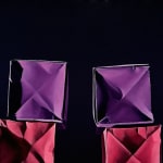 Paper boxes in two stacks on a purple to orange gradient