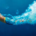 Oil painting of male swimmer in vast blue water on canvas