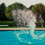 Splash from object submerging in pool above water
