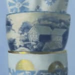 Middle detail of Stack of white and gold cups with ornate designs