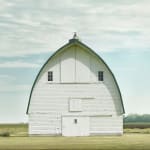 Jim Westphalen photograph of white barn in green field soft blue sky whispy clouds purchase at Gilman Contemporary