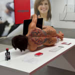 man on a desk hugging his computer