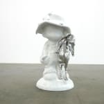 sculpture of a child wearing a hat and holding a bunny