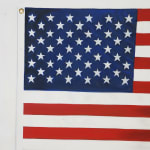 painting of an American Flag with extra red stripes making it longer