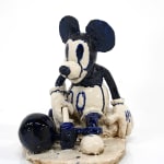 ceramic sculpture of mickey mouse with a ball and chain