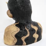 ceramic bust of a person with long hair and horns