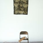 abstract sculpture with a flag with a face painted on it